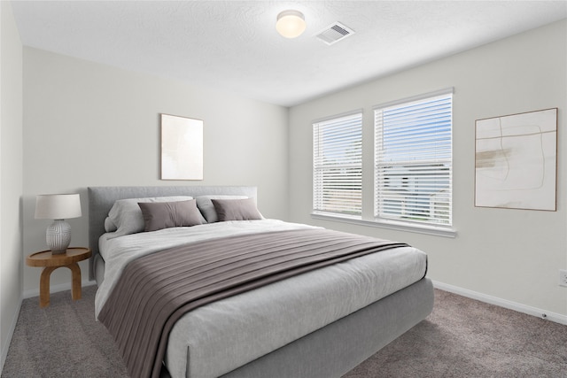 carpeted bedroom with a textured ceiling