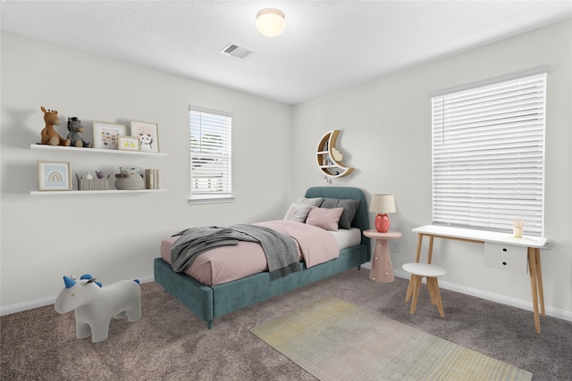 carpeted bedroom with baseboards and visible vents