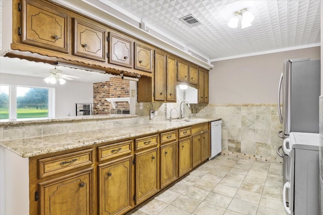 kitchen with white dishwasher, stainless steel fridge, ceiling fan, tile walls, and crown molding