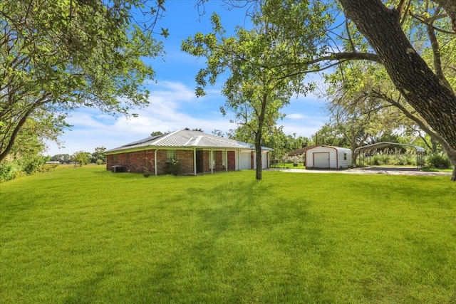 view of yard featuring an outbuilding and a garage