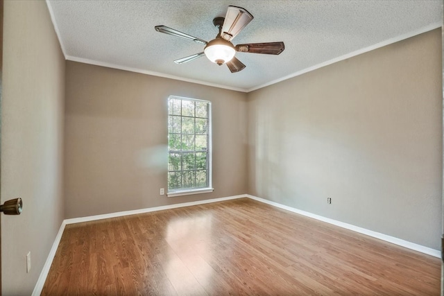 empty room with ornamental molding, hardwood / wood-style flooring, a textured ceiling, and ceiling fan