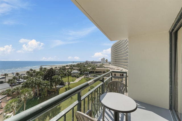 balcony with a water view and a beach view