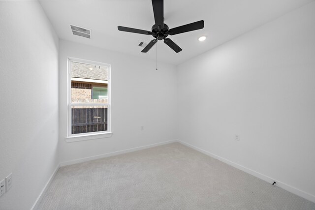 carpeted empty room featuring ceiling fan