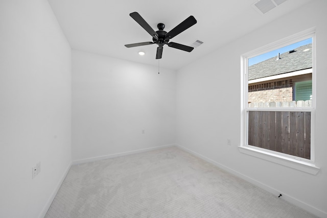 unfurnished room featuring light carpet and ceiling fan