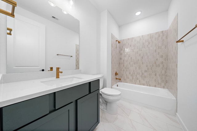 full bathroom featuring tiled shower / bath, vanity, and toilet