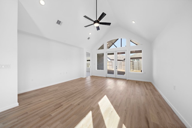 unfurnished living room with french doors, ceiling fan, high vaulted ceiling, and light hardwood / wood-style floors