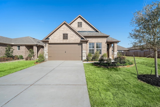 view of front of home with a garage and a front lawn