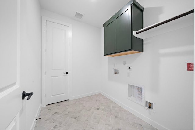 washroom featuring electric dryer hookup, washer hookup, hookup for a gas dryer, and cabinets