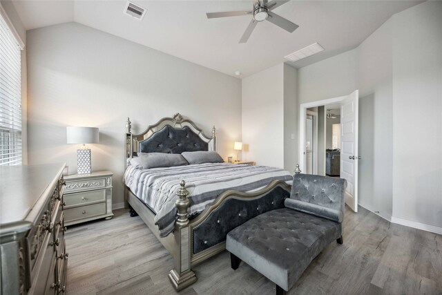 bedroom with lofted ceiling, light hardwood / wood-style floors, and ceiling fan