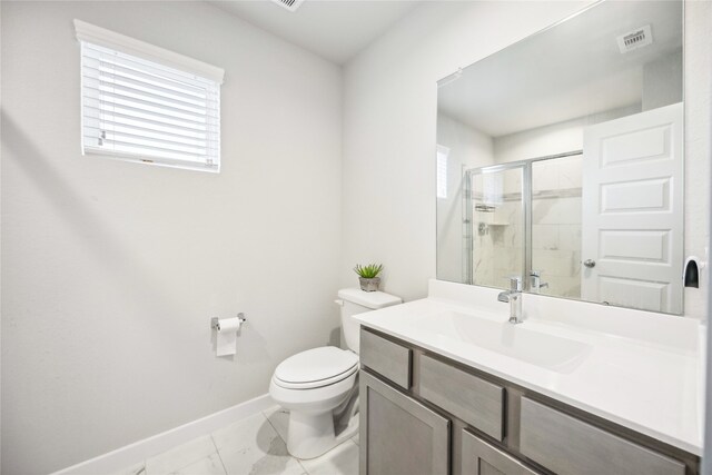 bathroom featuring vanity, toilet, and an enclosed shower