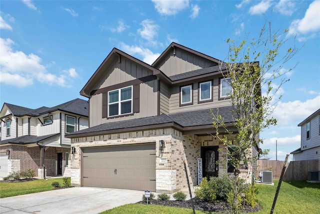 craftsman inspired home featuring central air condition unit, a front yard, and a garage