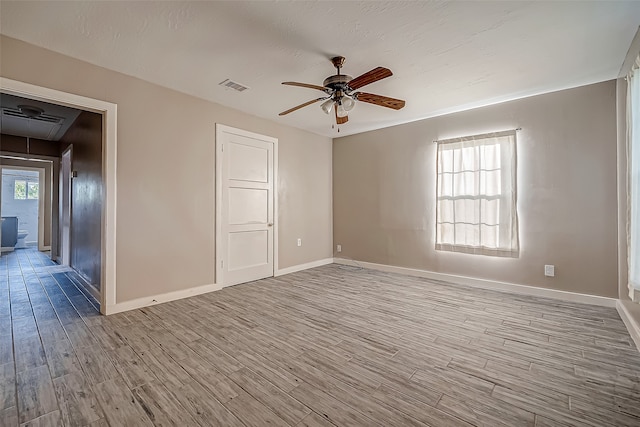 unfurnished room featuring light hardwood / wood-style flooring and ceiling fan