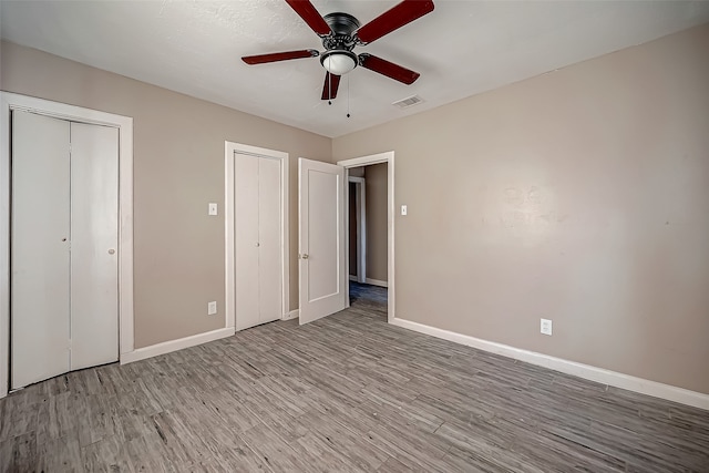 unfurnished bedroom with light hardwood / wood-style flooring and ceiling fan