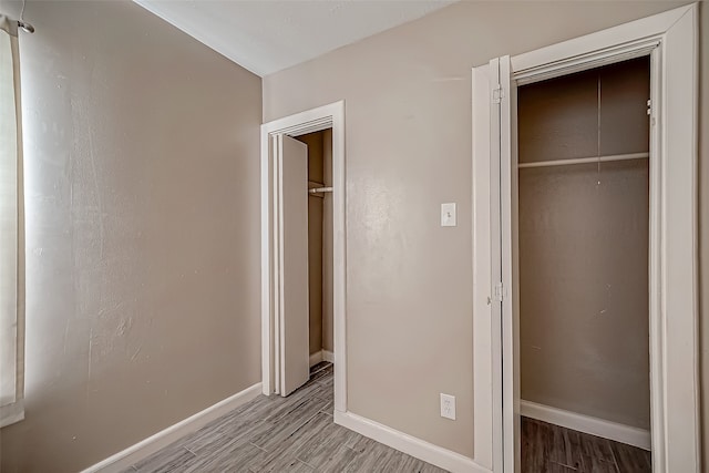 unfurnished bedroom with a closet and light hardwood / wood-style flooring