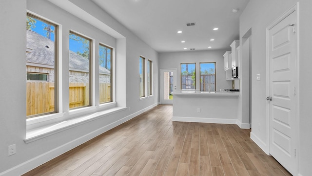 spare room featuring recessed lighting, light wood-type flooring, visible vents, and baseboards