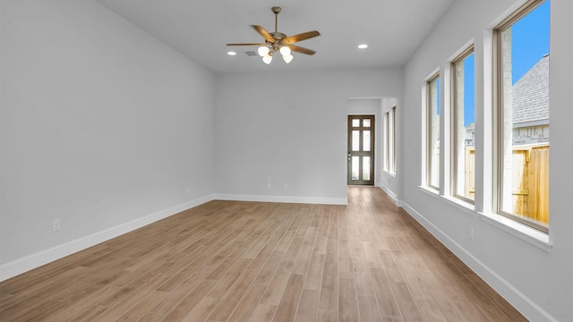 unfurnished room featuring light wood finished floors, recessed lighting, a ceiling fan, and baseboards