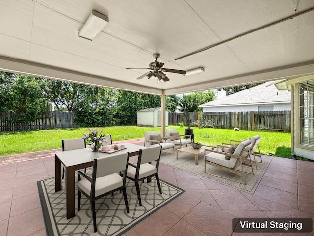 view of patio featuring outdoor lounge area, ceiling fan, and a storage unit