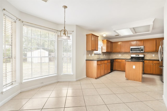 kitchen featuring decorative backsplash, appliances with stainless steel finishes, light tile patterned floors, decorative light fixtures, and a center island