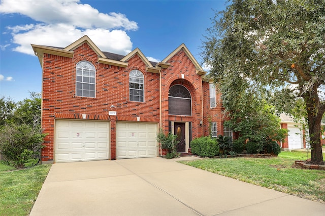 view of front of home with a front lawn and a garage