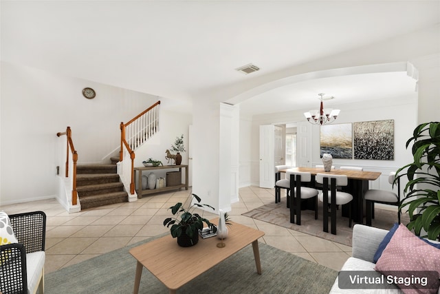 living room with a notable chandelier and light tile patterned floors