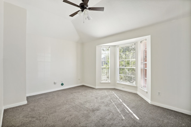 unfurnished room featuring carpet flooring, ceiling fan, and vaulted ceiling