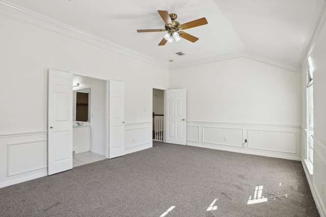 unfurnished bedroom with light carpet, crown molding, ceiling fan, and lofted ceiling