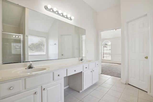 bathroom with tile patterned flooring, vanity, lofted ceiling, and walk in shower