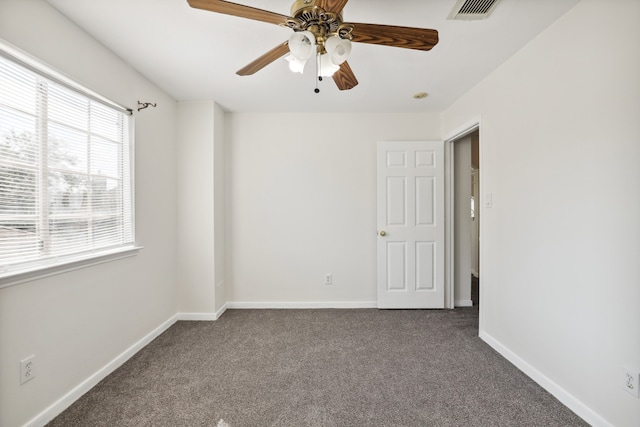 carpeted spare room with ceiling fan