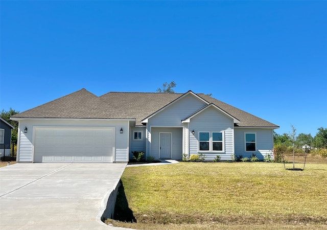 ranch-style home featuring a front yard and a garage