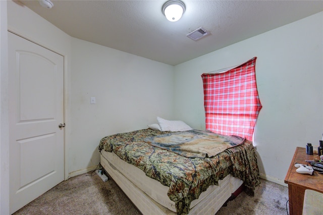 bedroom with a textured ceiling and carpet flooring