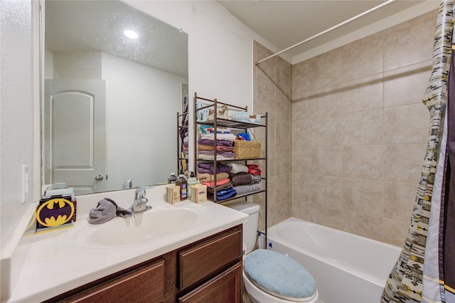 full bathroom with vanity, shower / tub combo with curtain, and toilet