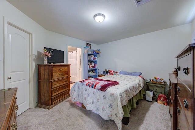 carpeted bedroom with ensuite bathroom