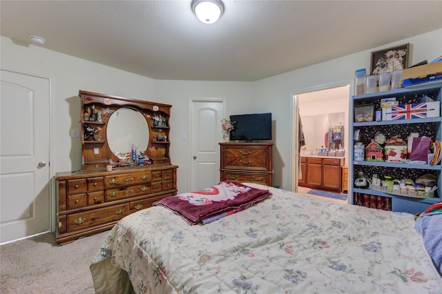 bedroom with connected bathroom and carpet