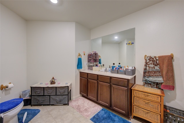 bathroom featuring vanity, toilet, and tile patterned floors