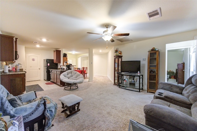 living room with light colored carpet and ceiling fan