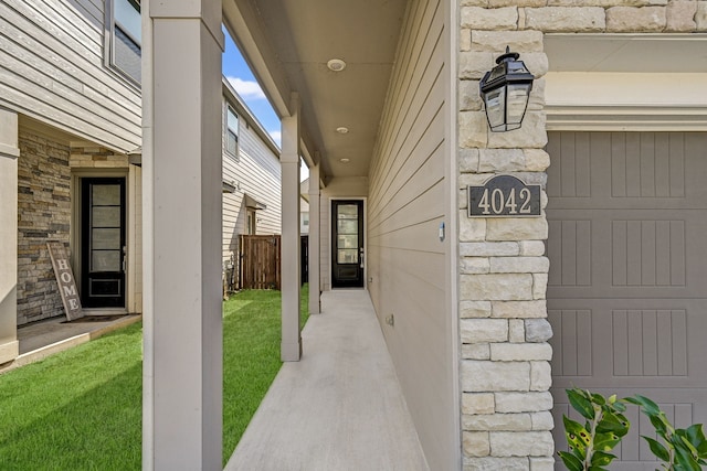 doorway to property featuring a lawn