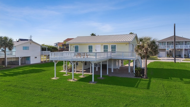 rear view of property featuring a carport and a lawn