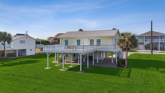 back of property featuring a yard, stairs, and metal roof