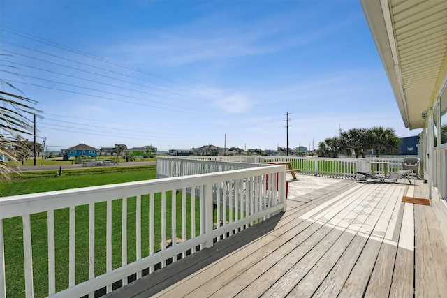 wooden deck with a lawn