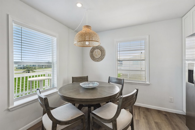 dining area featuring wood-type flooring and a wealth of natural light