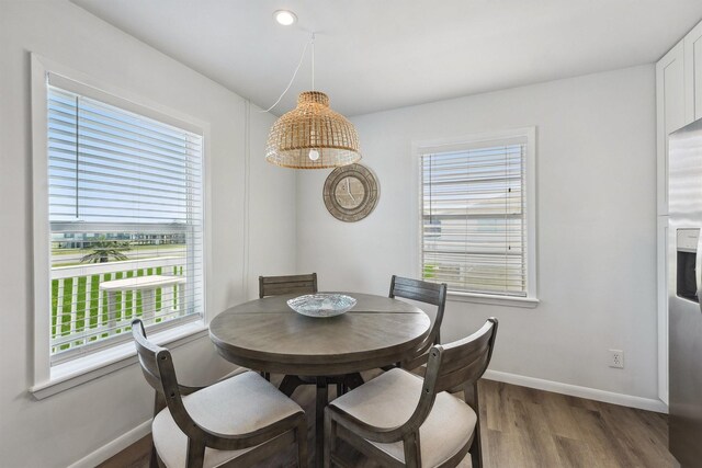 dining room featuring wood finished floors and baseboards