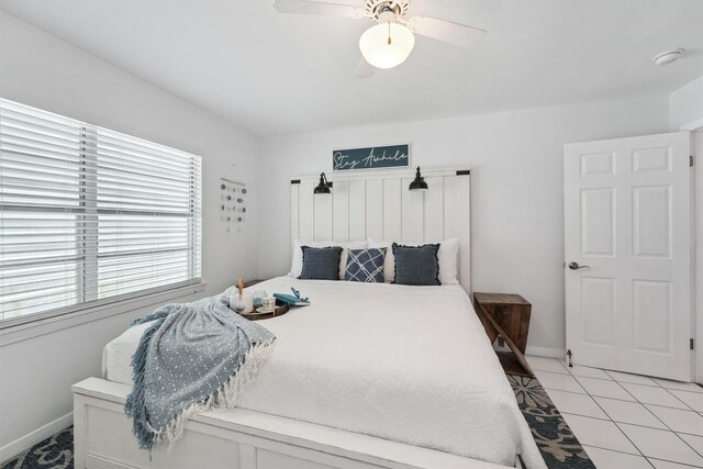 bedroom featuring light tile patterned floors, baseboards, and ceiling fan