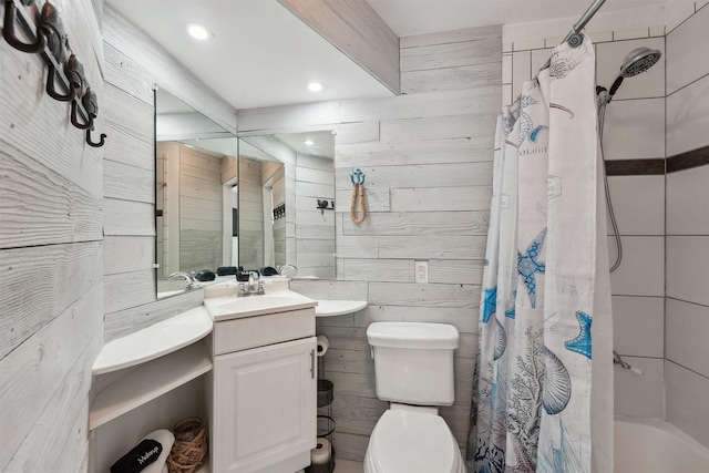 full bathroom with vanity, toilet, shower / tub combo, and wooden walls