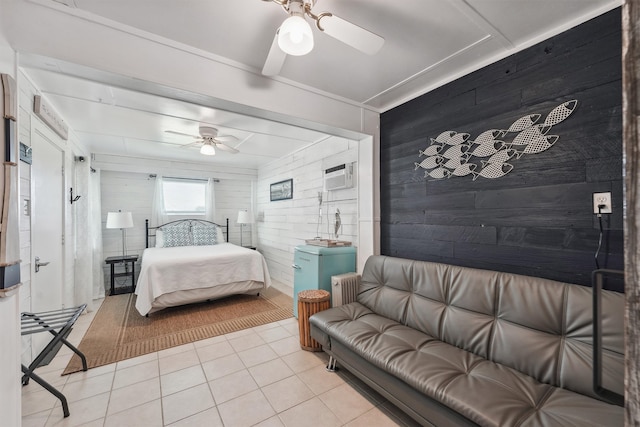 tiled bedroom with wooden walls, a wall unit AC, radiator, and ceiling fan