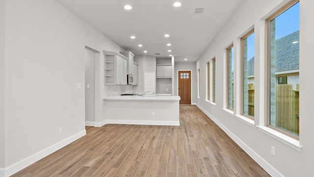 unfurnished living room featuring light wood-type flooring