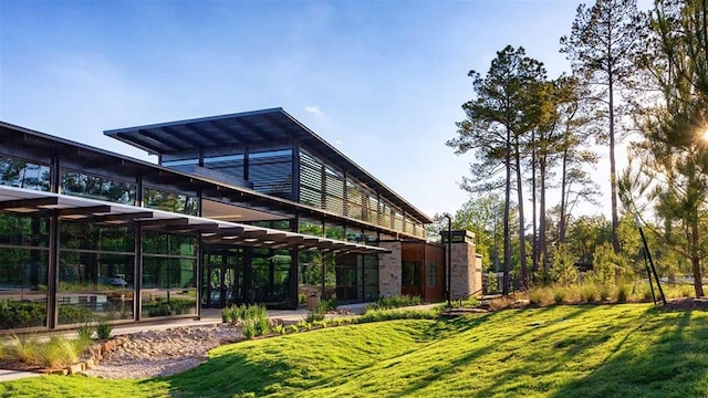 rear view of property with a lawn