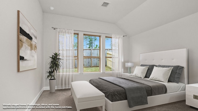 bedroom with carpet floors and lofted ceiling