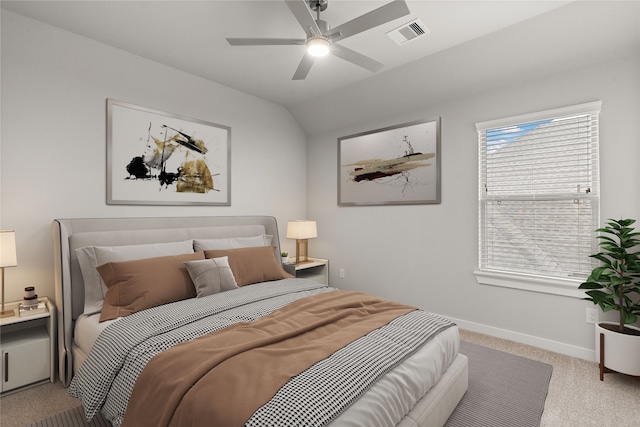 bedroom with lofted ceiling, multiple windows, ceiling fan, and light carpet