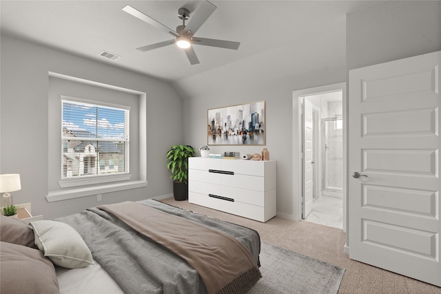 bedroom featuring lofted ceiling, light colored carpet, ceiling fan, and ensuite bathroom