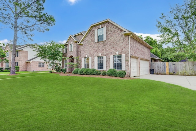 view of front of property with a front yard and a garage